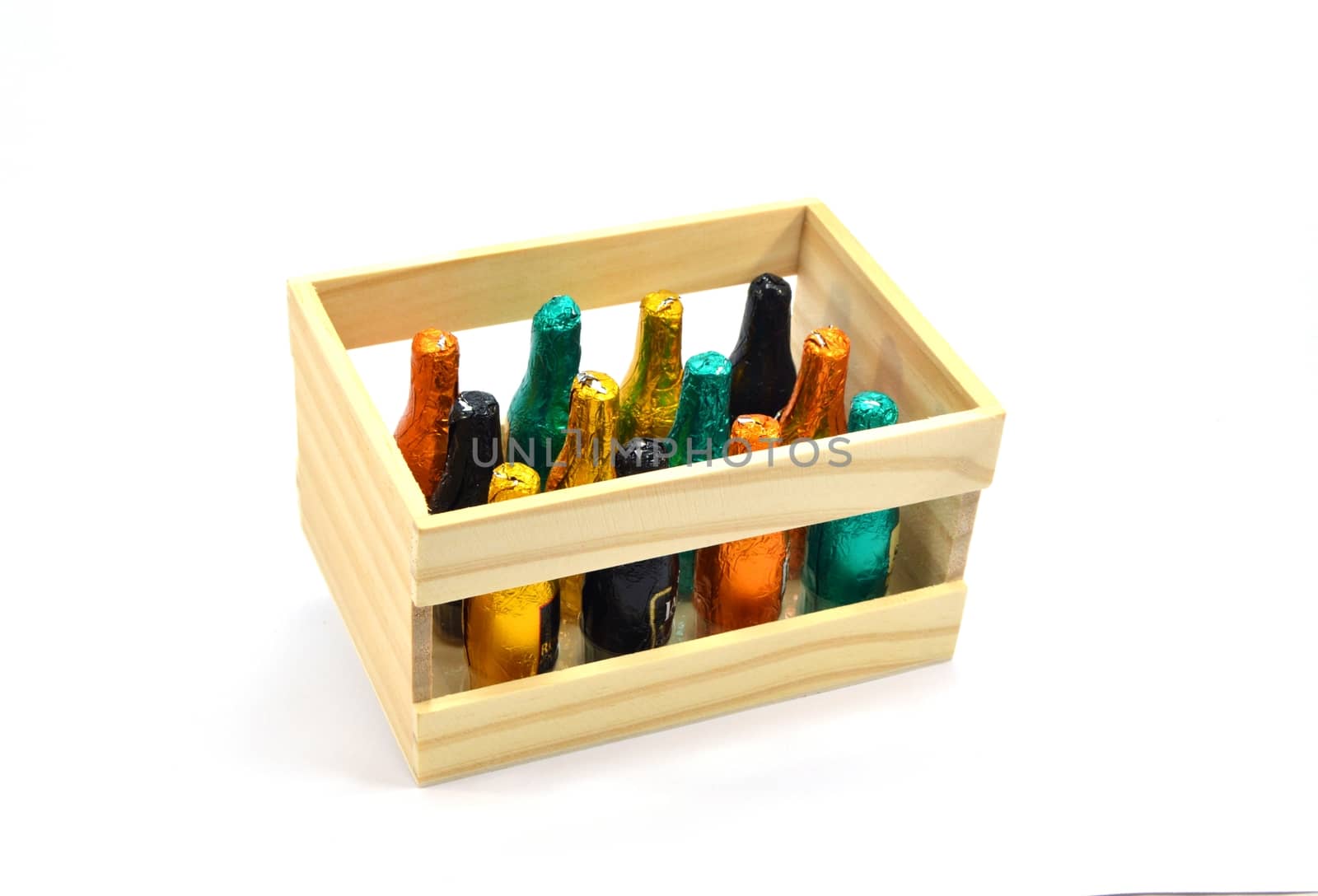 Wooden box of twelve bottles of chocolate filled with liqueur on a white background