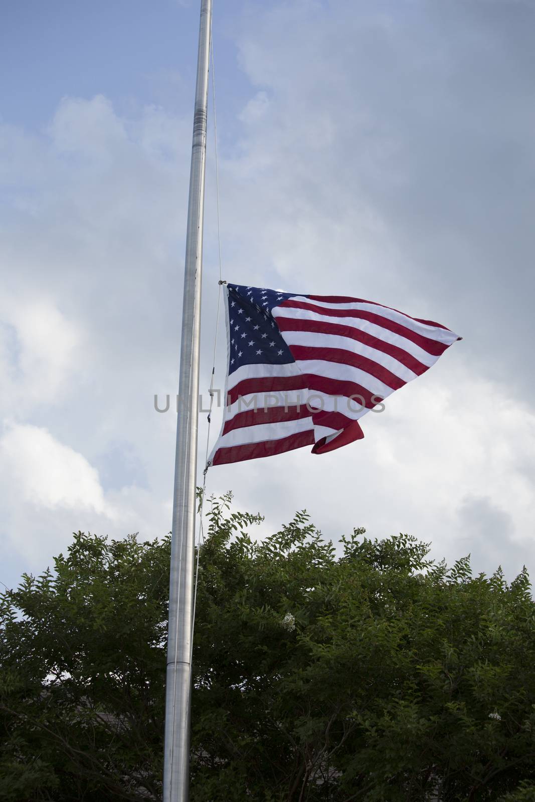 American flag at half mast for mourning and holidays