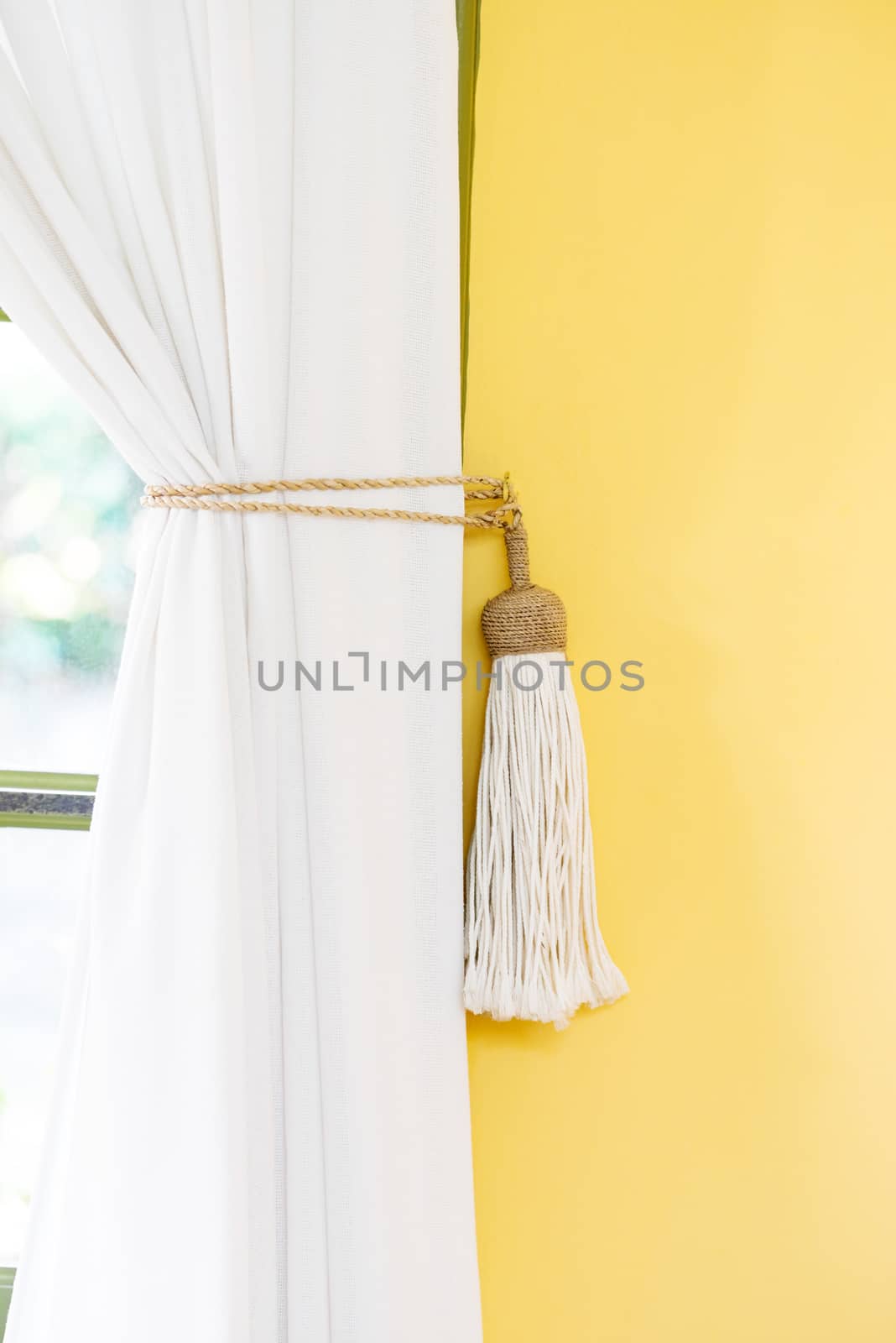 White curtain tie-back home decor simple style indoors yellow wall by Altinosmanaj