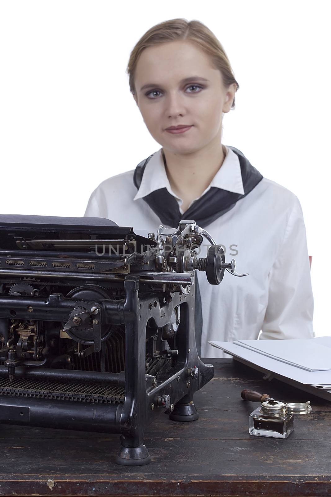 Nice girl for a vintage typewriter in a retro style on a white background