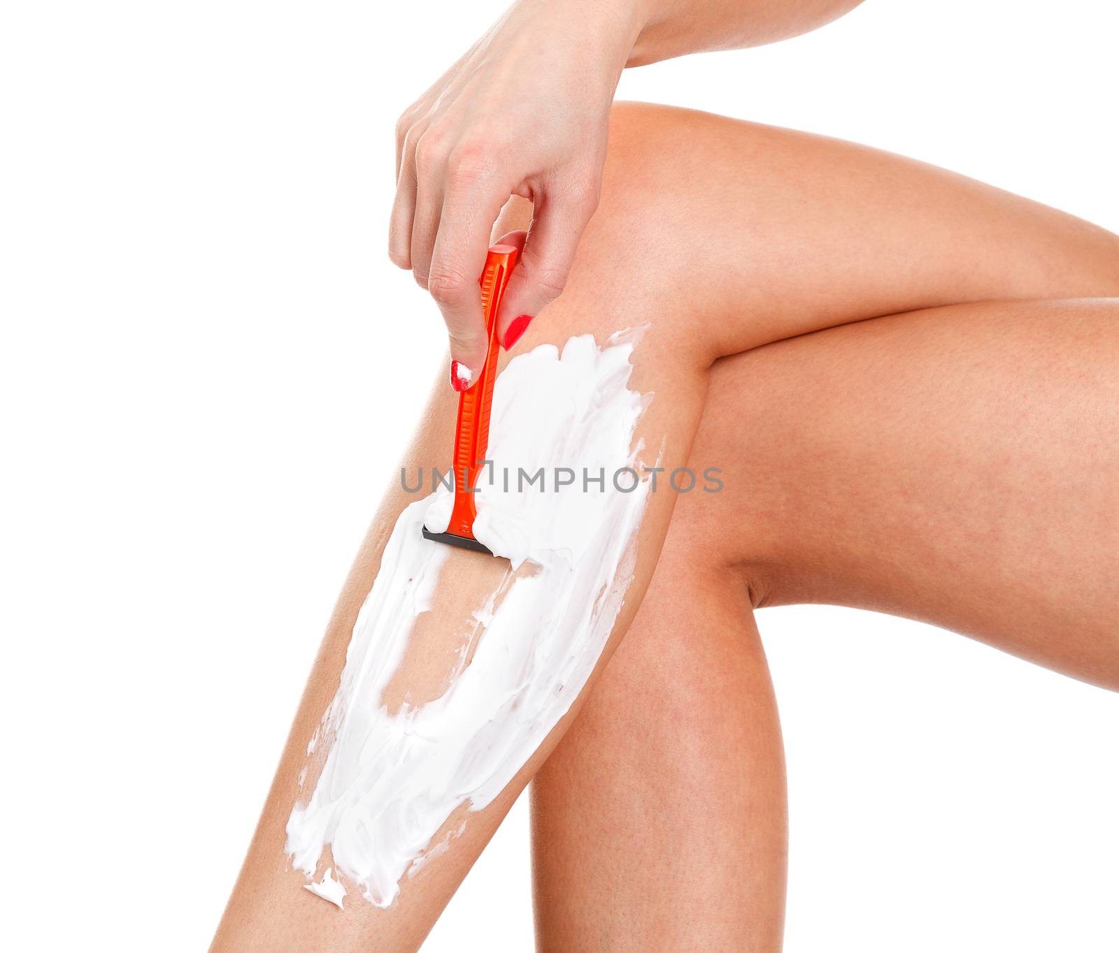 Woman shaves her leg, isolated on white background