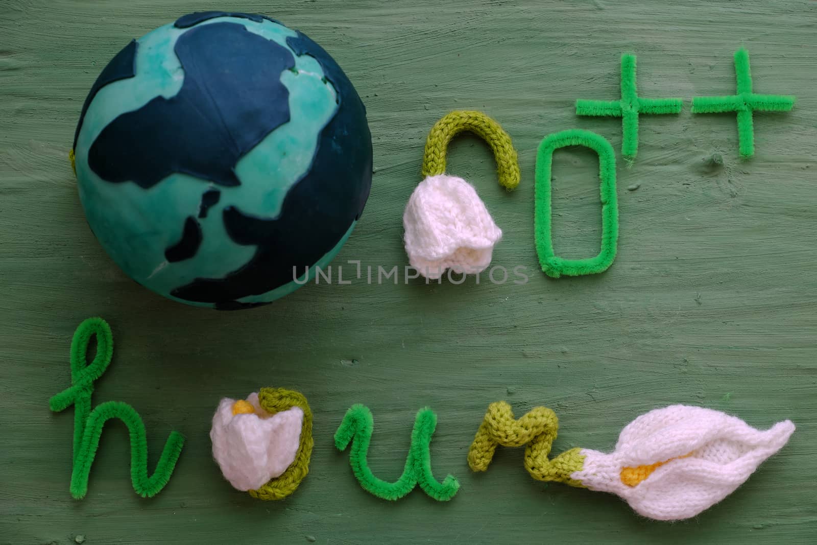 Earth hour message on green background for special day, a day to remind people give hand save the earth, green letter with white flower symbol for turn off light on 60 minute