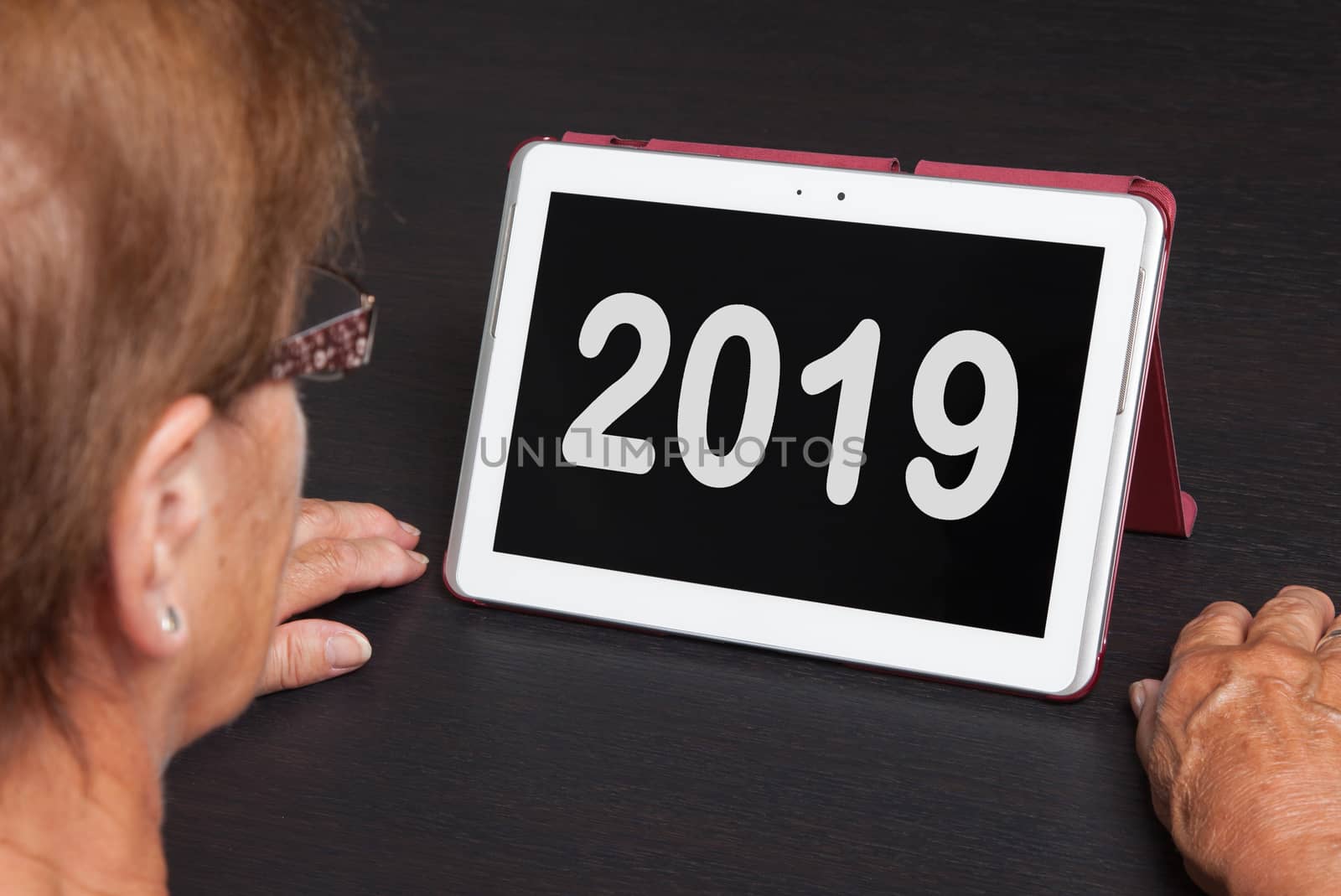 Senior lady relaxing and her tablet - New year - 2019