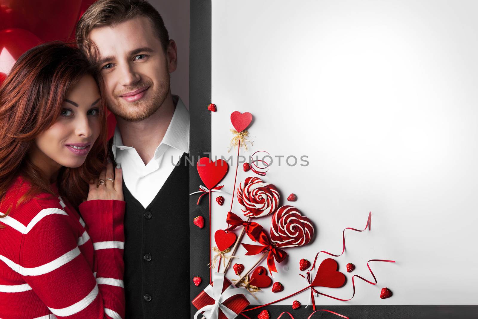 Happy couple posing with Valentine's day decoration with white copy space