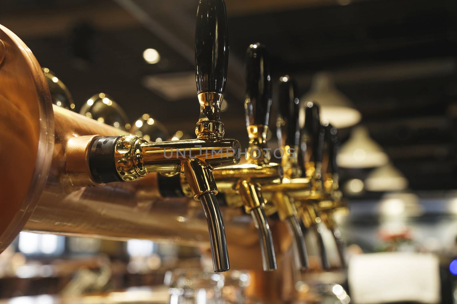 golden shiny beer taps in beer bar