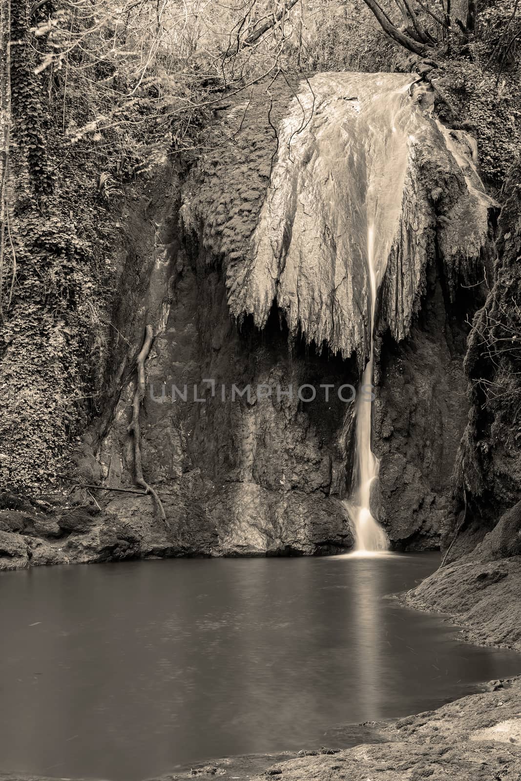 A small waterfall with pond below near Marmore waterfalls in black and white