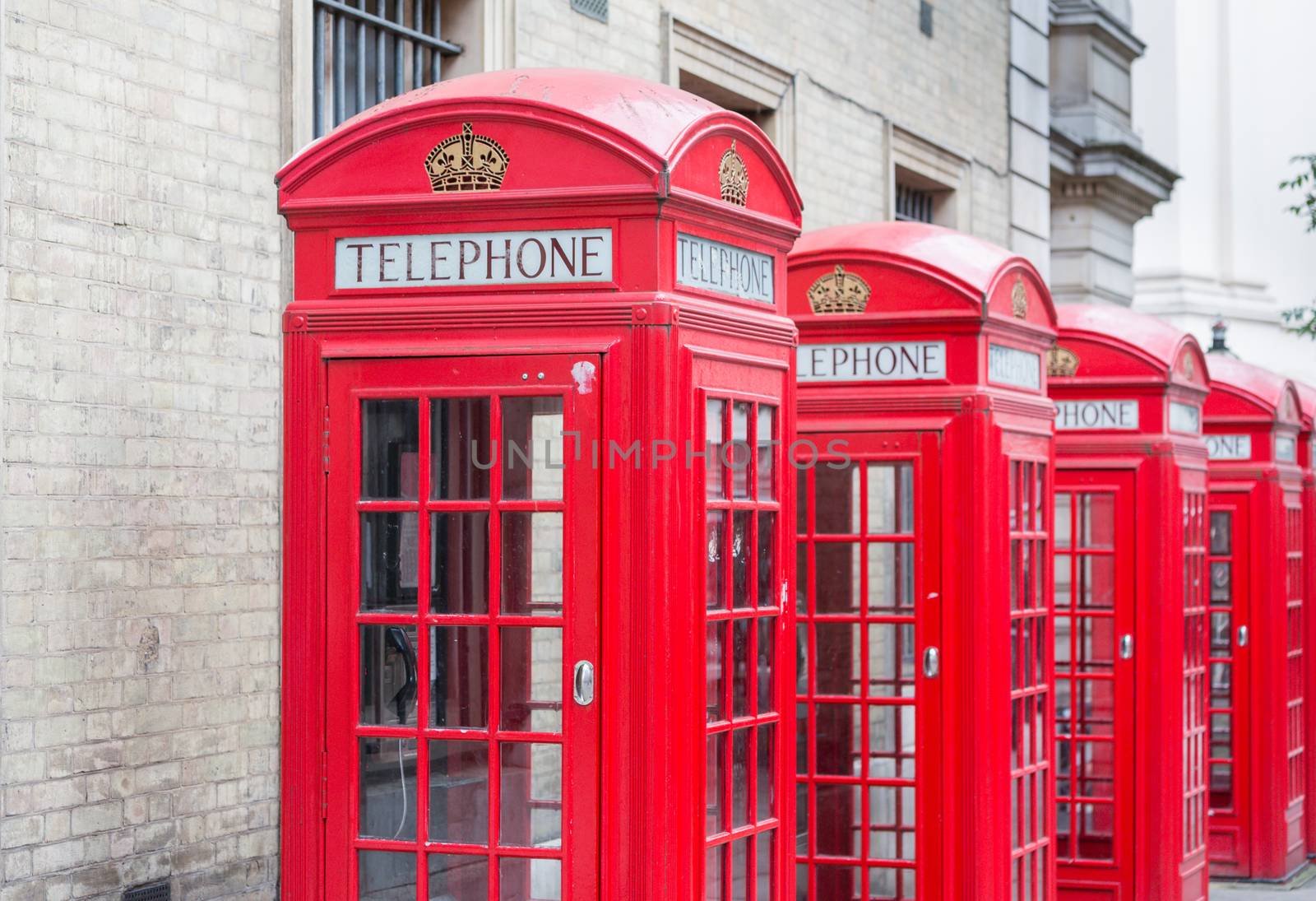 Five Red London Telephone boxes all in a row in the City