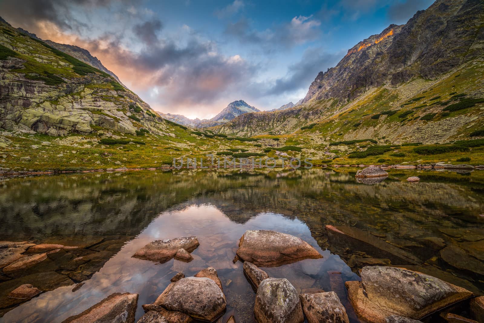 Mountain Lake Above Skok Waterfall with Rocks in Foreground and Strbsky Peak in Background at Sunset. Mlynicka Valley, High Tatra, Slovakia.