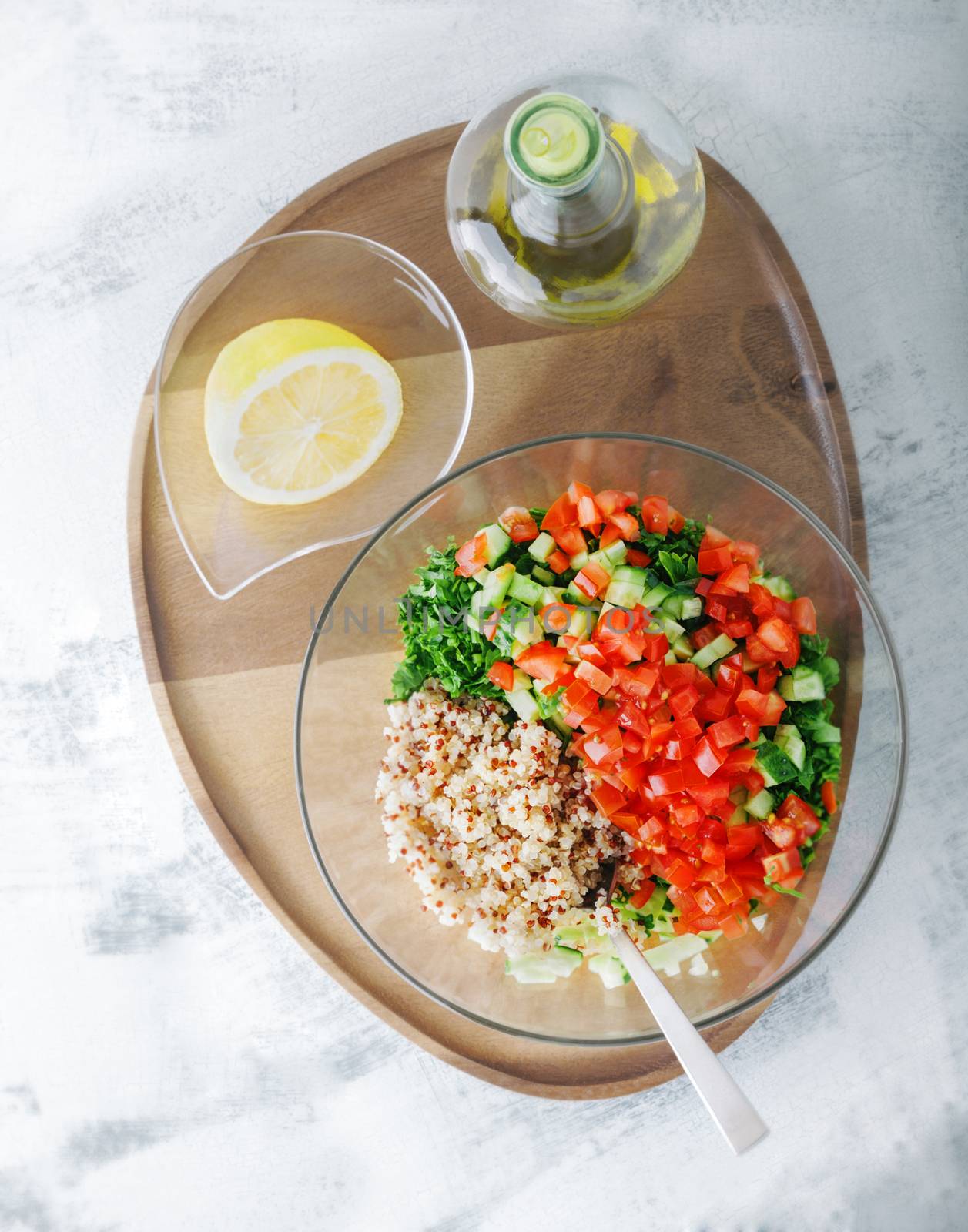 Quinoa tabbouleh salad on a wooden table by supercat67