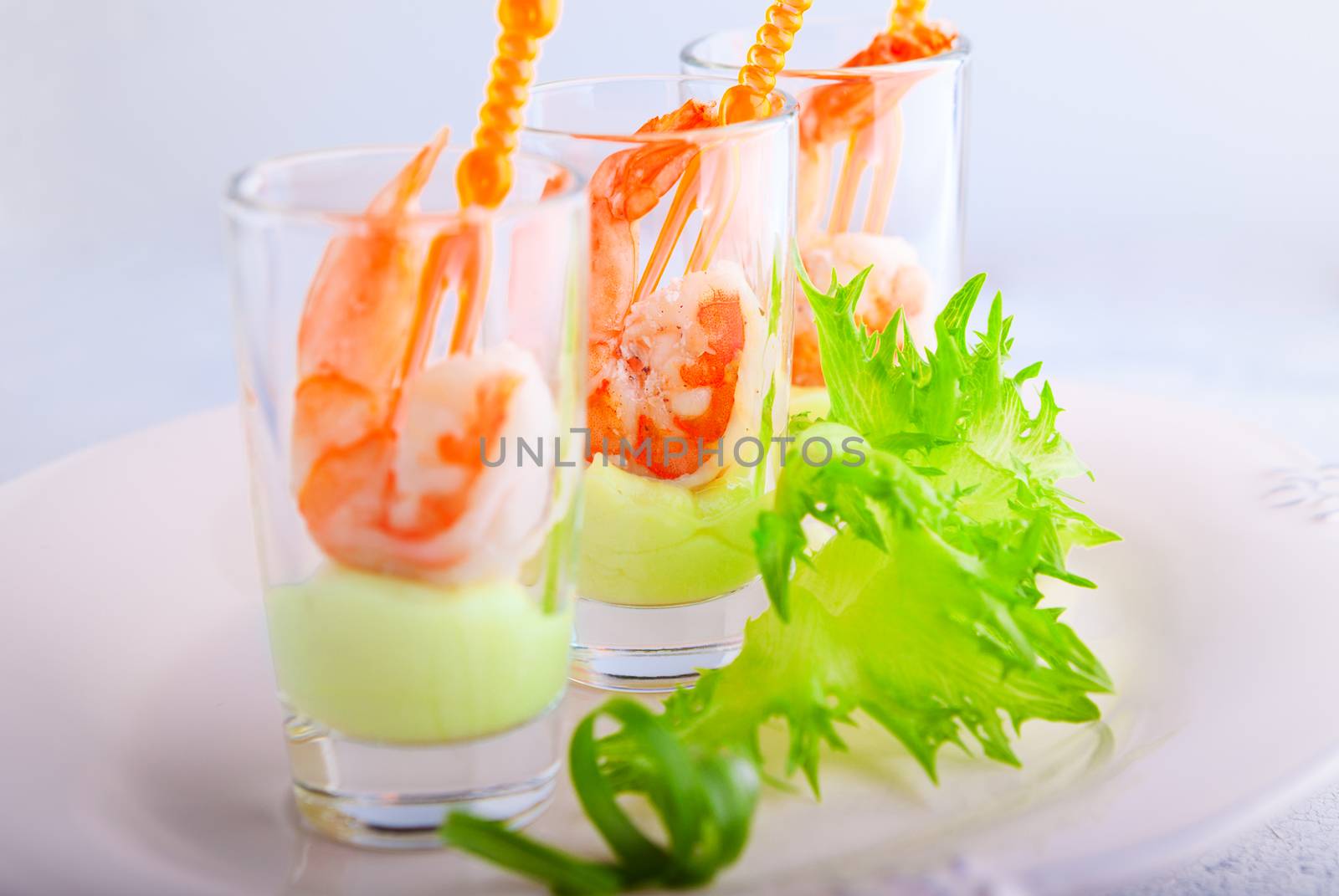 Shrimp with avocado yogurt in a glass .