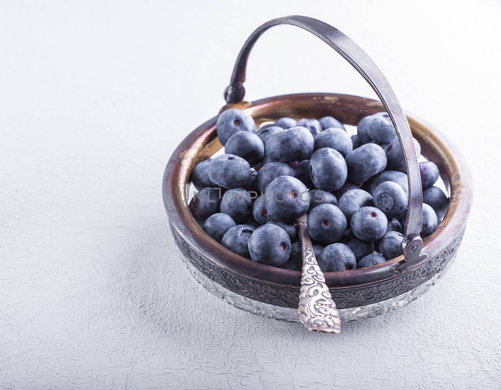 Fresh Blueberry and spoon on a wooden table