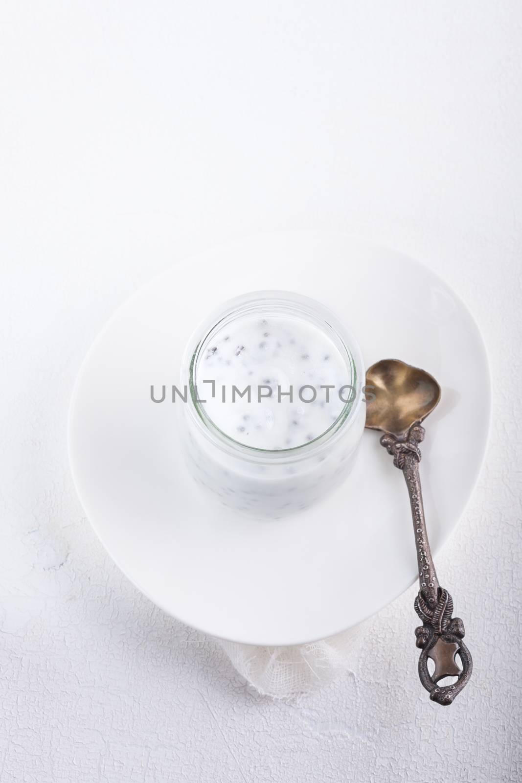 Yogurt with chia seeds on a white background