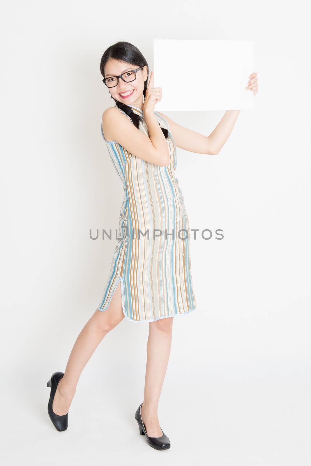 Oriental girl holding white blank paper card by szefei