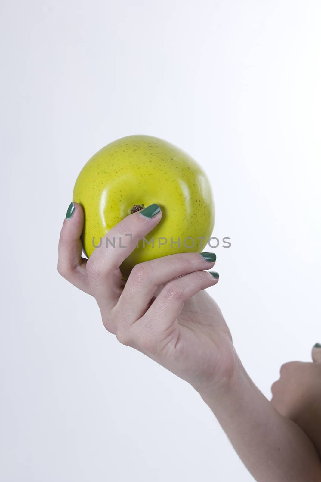 Green apple in hand on white background