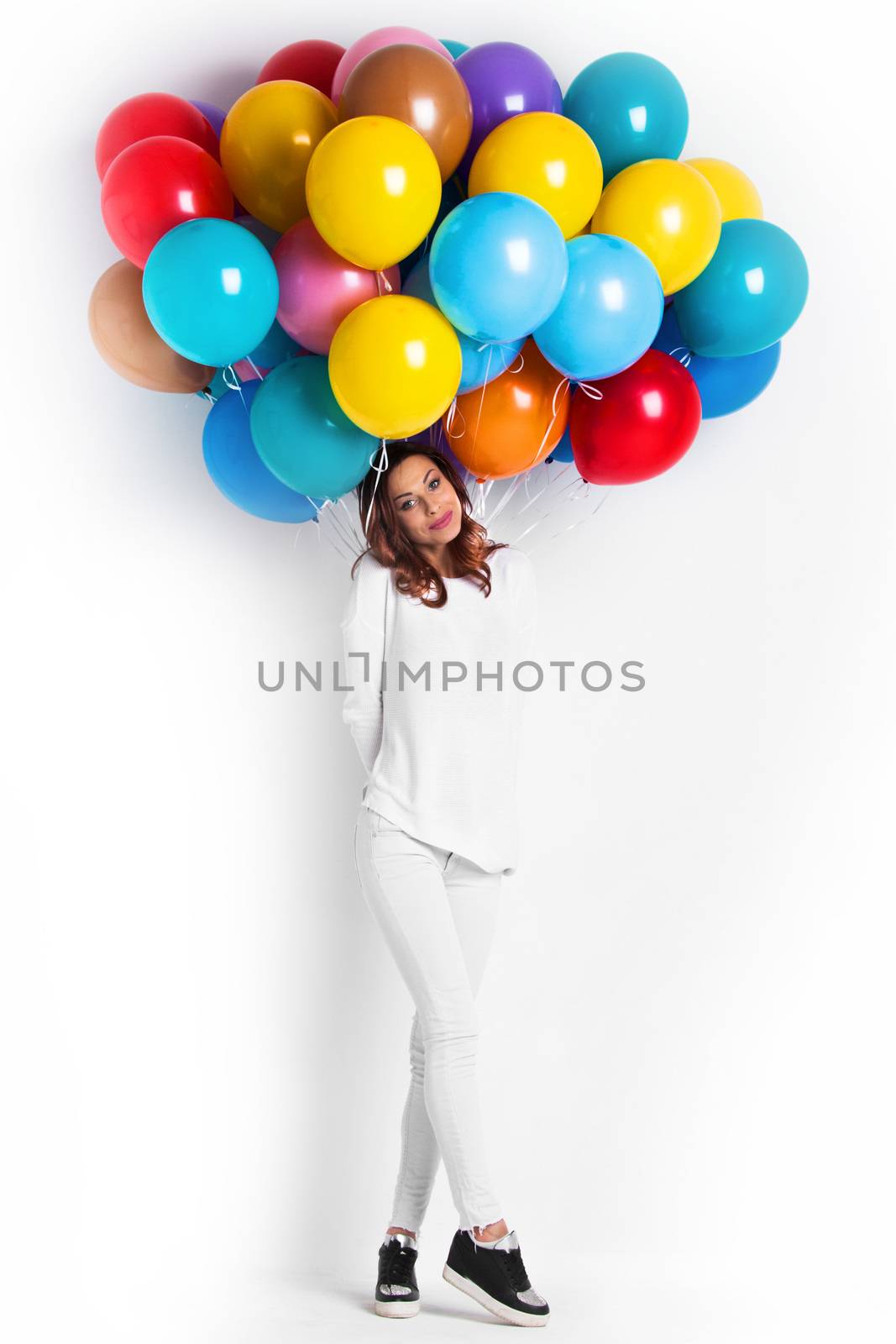 Happy woman with many colorful balloons