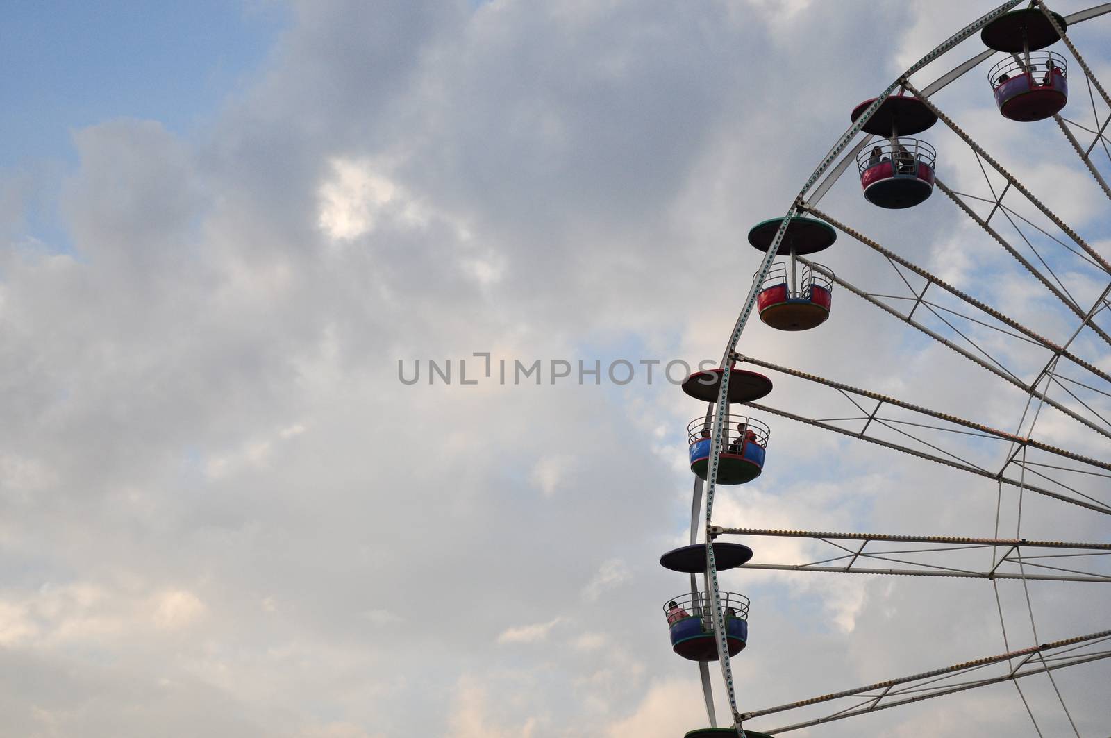the swing cable basket ferris wheel on blue sky cloud background at amusement park is the family vacation activity on holiday