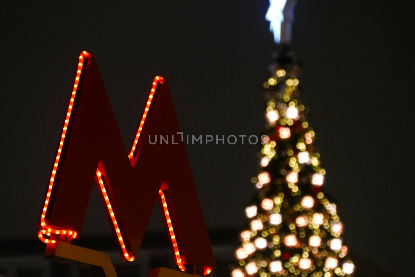 M symbol of the underground against the backdrop of the Christmas tree by L86