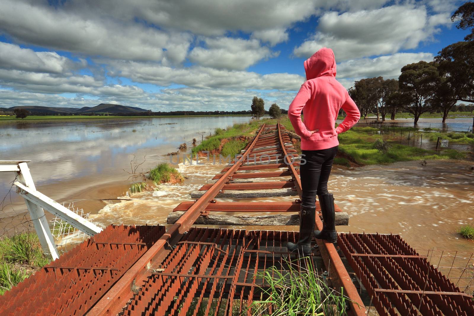 Floodwaters run under buckled train tracks by lovleah