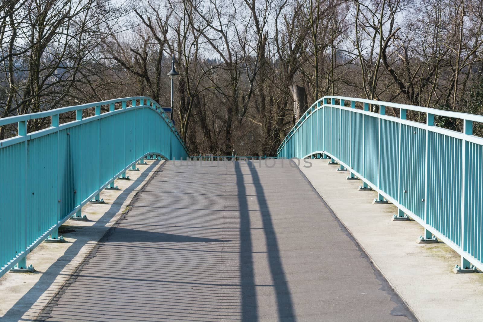 Pedestrian bridge steel arch structure over the river Ruhr in Muelheim, Germany.