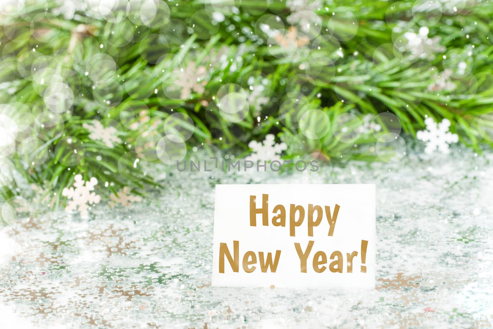 Fir tree branch and snow flares confetti with Happy New Year text lettering. New Year concept