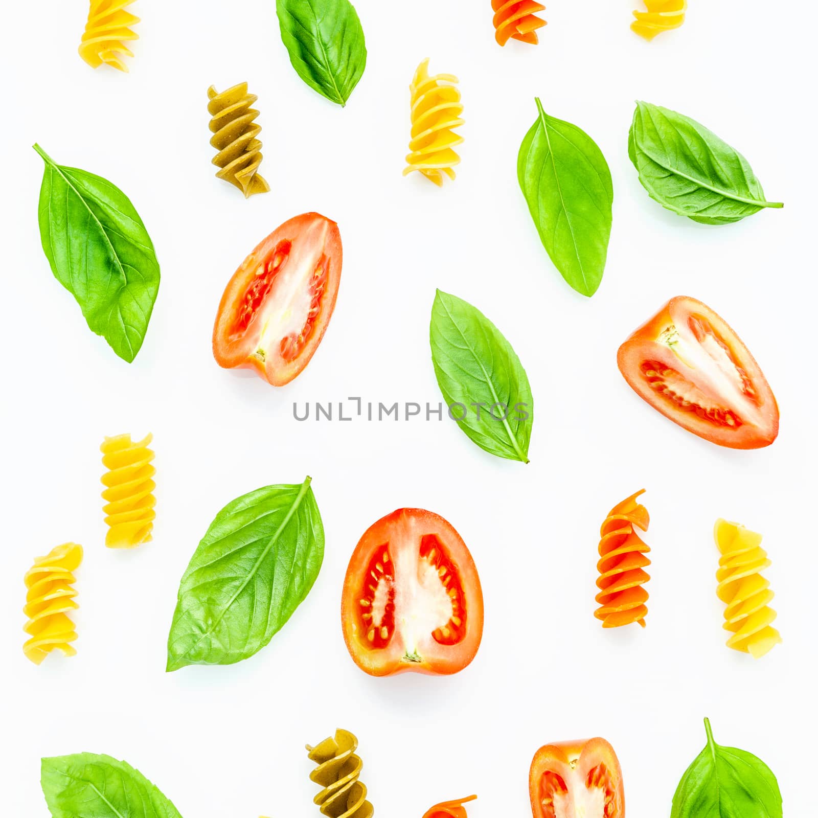 Italian food concept Fusilli with tomato and sweet basil isolate on white background. Fusilli and ingredients with flat lay.
