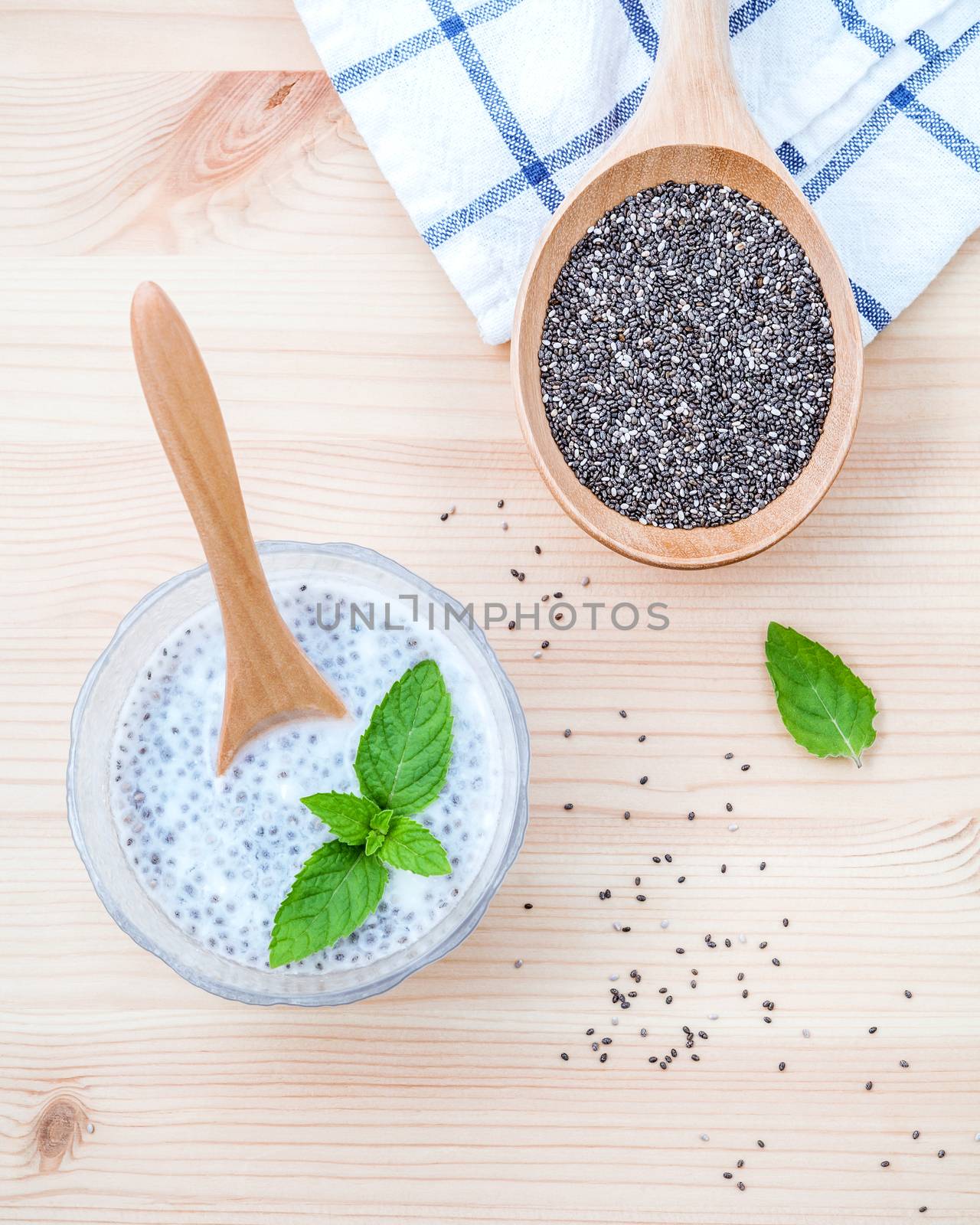 Nutritious chia seeds in glass bowl with wooden spoon for diet f by kerdkanno