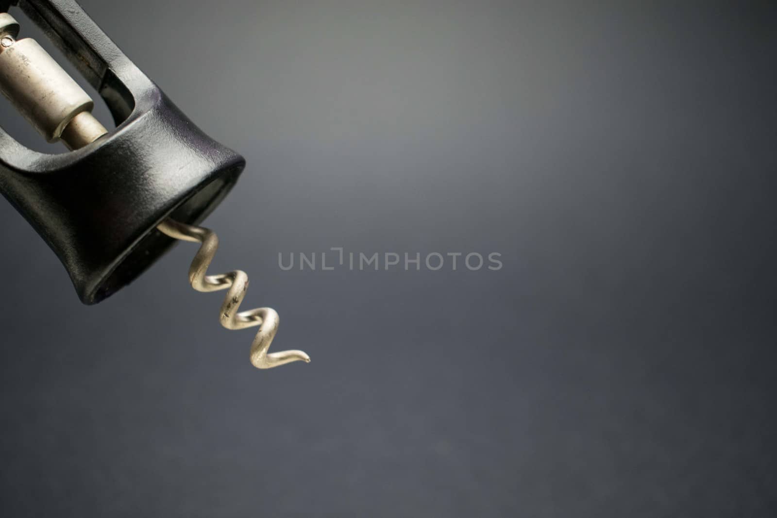 A corkscrew, tool used to open bottles of wine