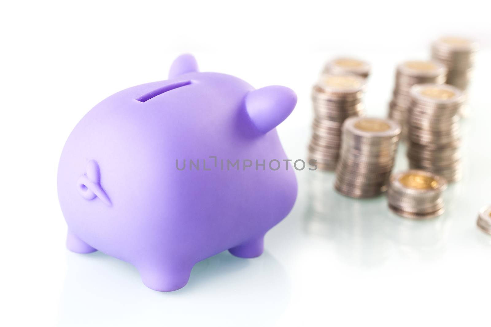 Financial concept with piggy bank, pile of money on white background