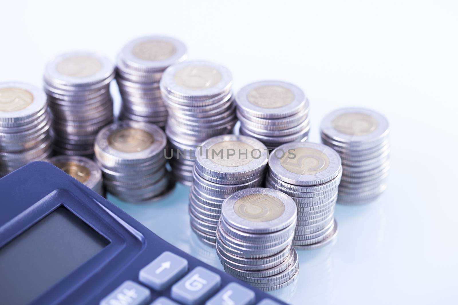 counting income, pile of money, calculator in white background