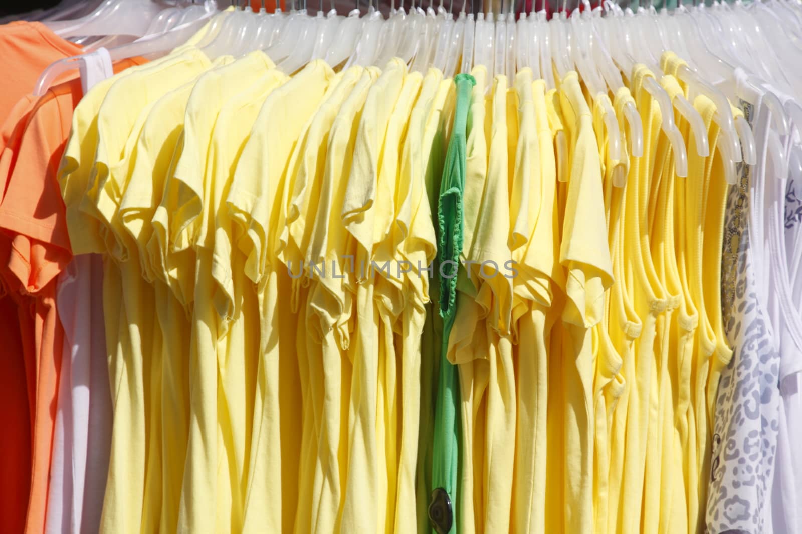 Colorful shirts on a clothes rail