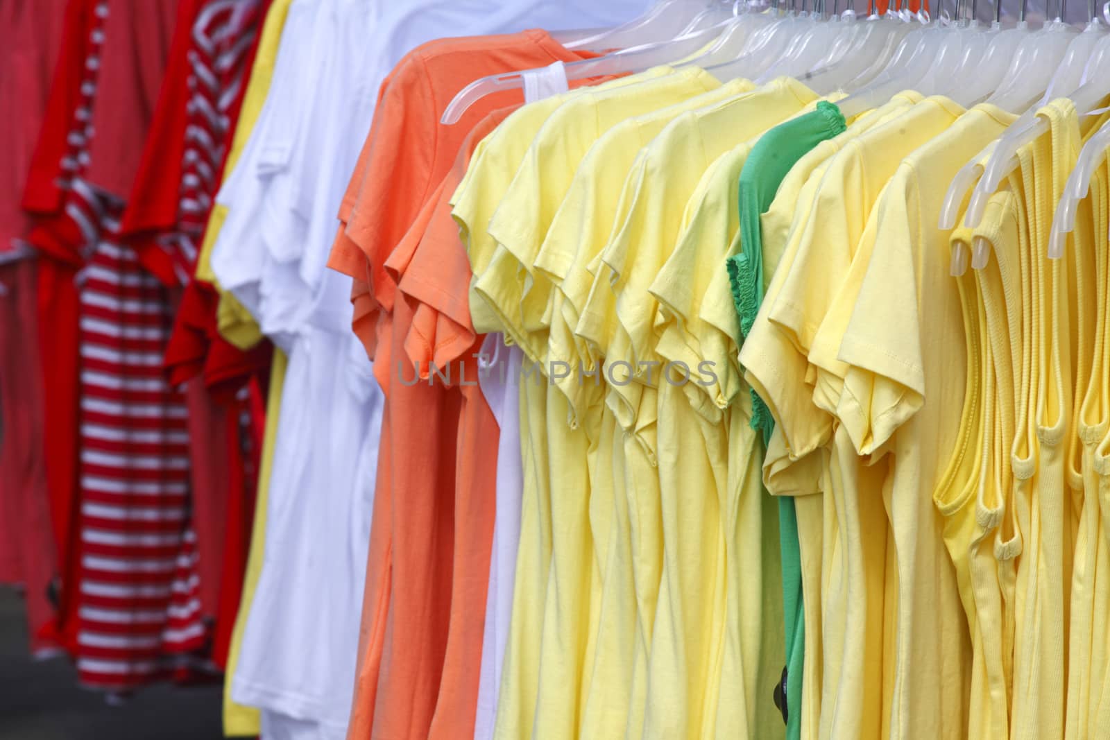 Colorful shirts on a clothes rail