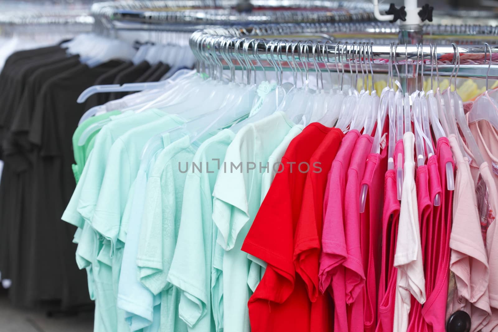 Colorful shirts on a clothes rail