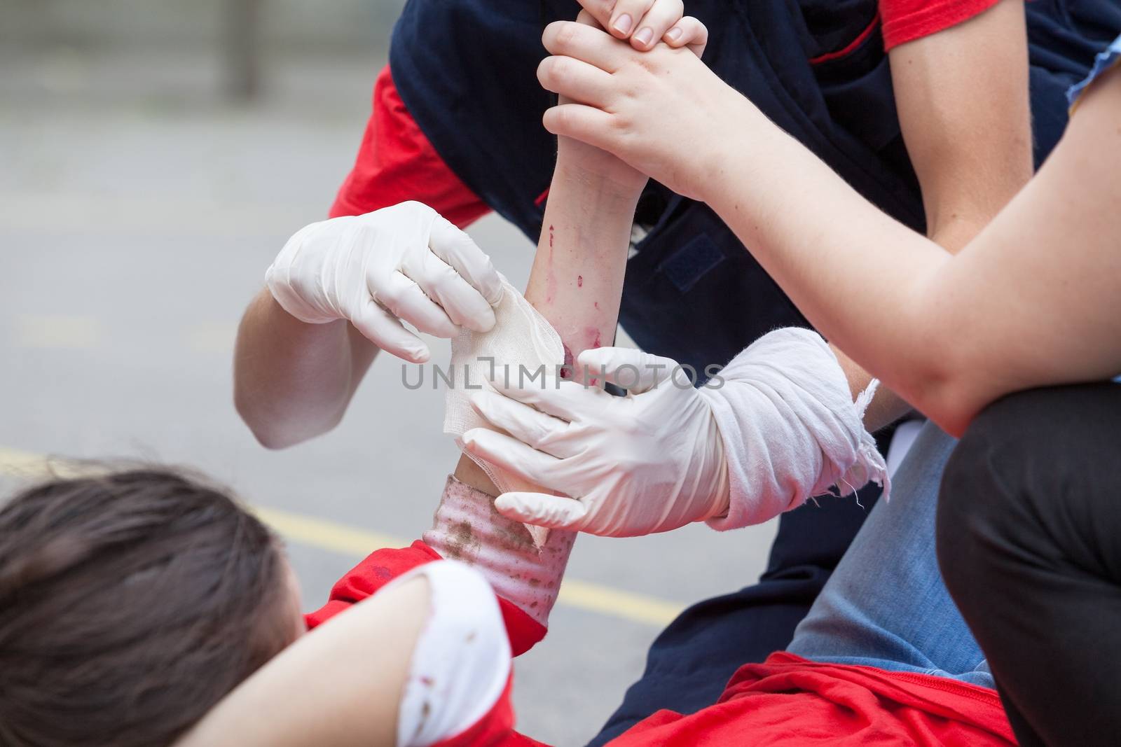 Paramedic giving help to an injured person after accident by wellphoto