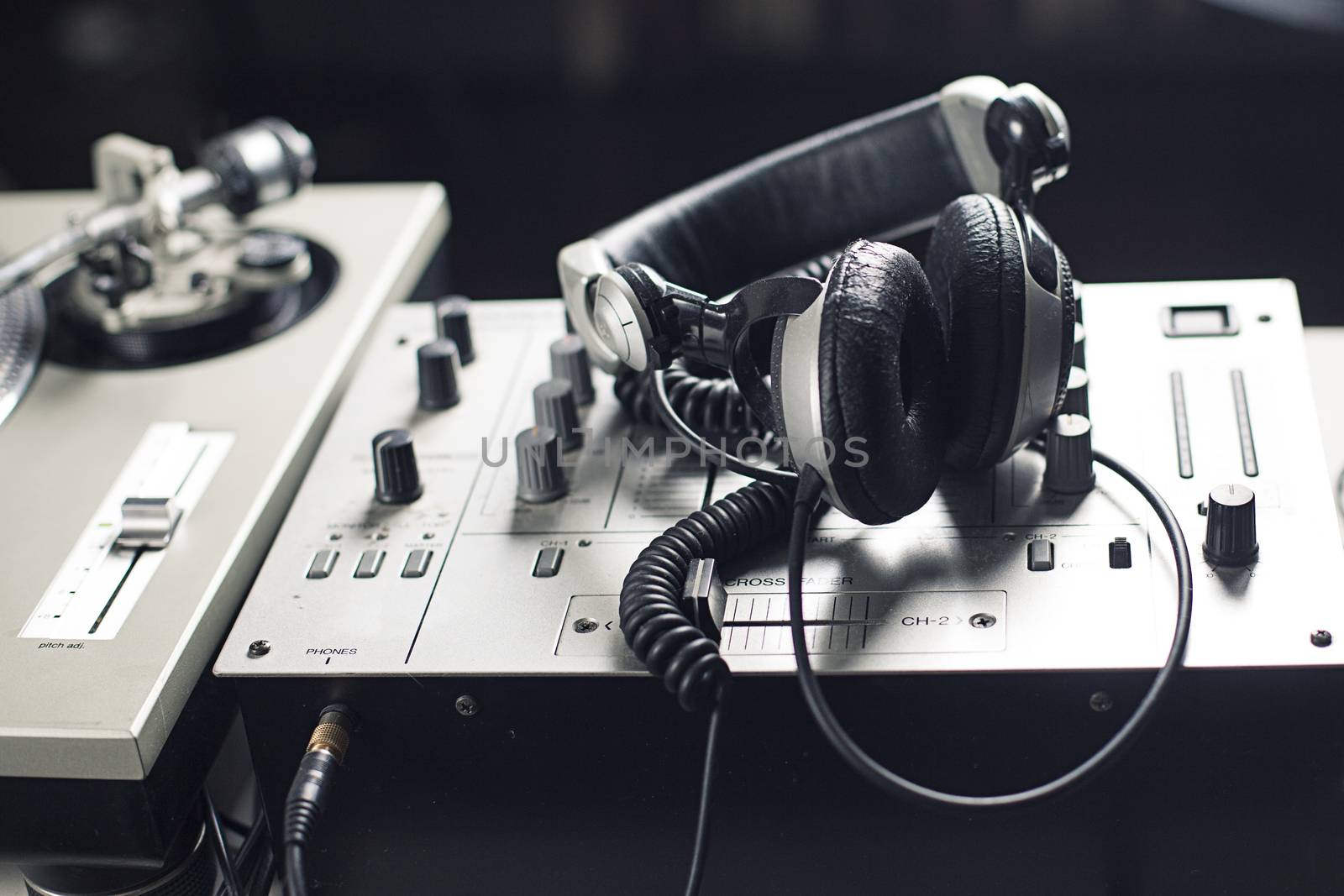 DJ mixer and headphones with a vinyl record, close up.