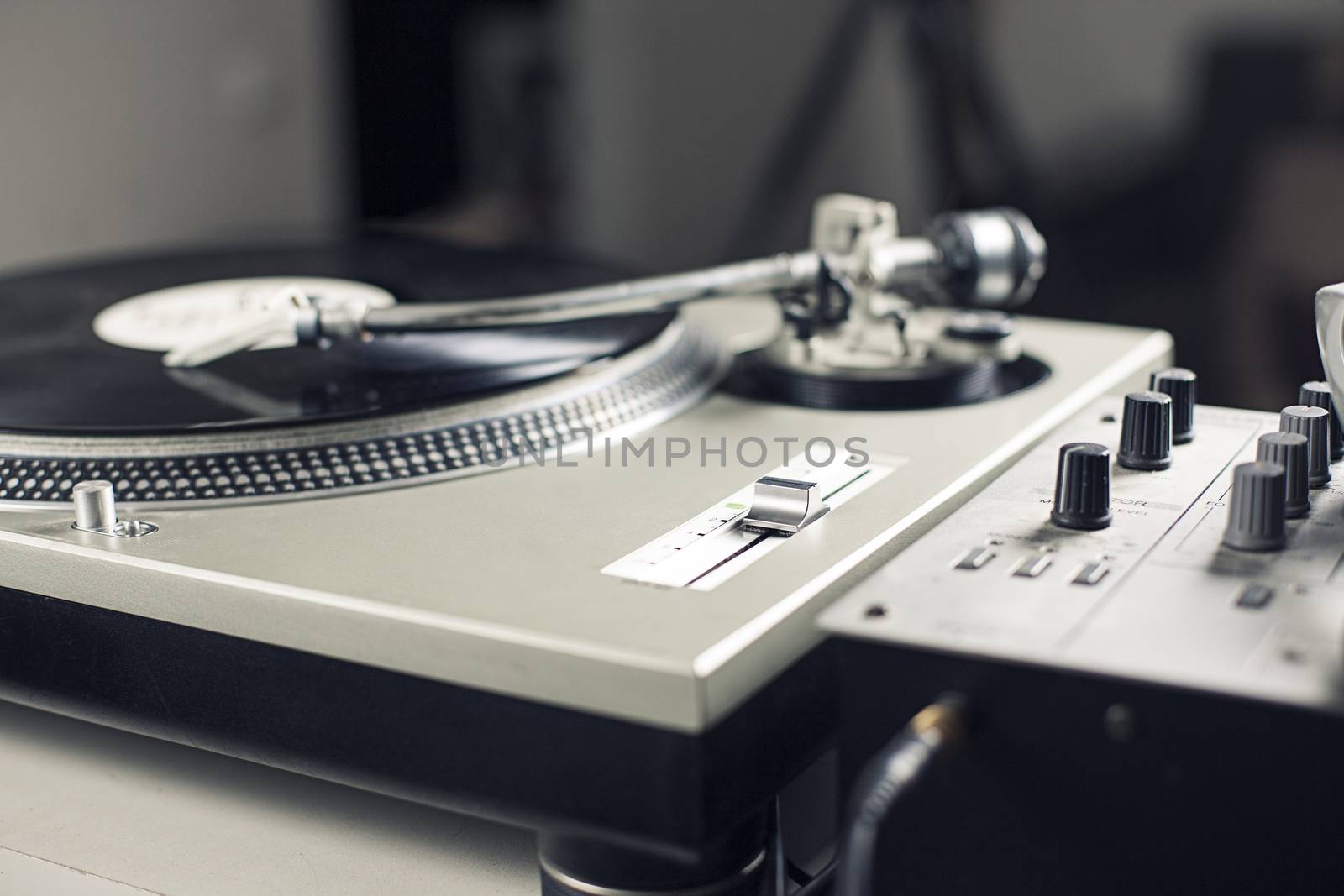 DJ mixer with a vinyl record, close up. 