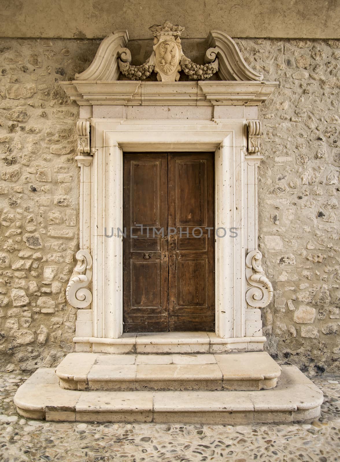 The entrance wooden door in an old Italian house