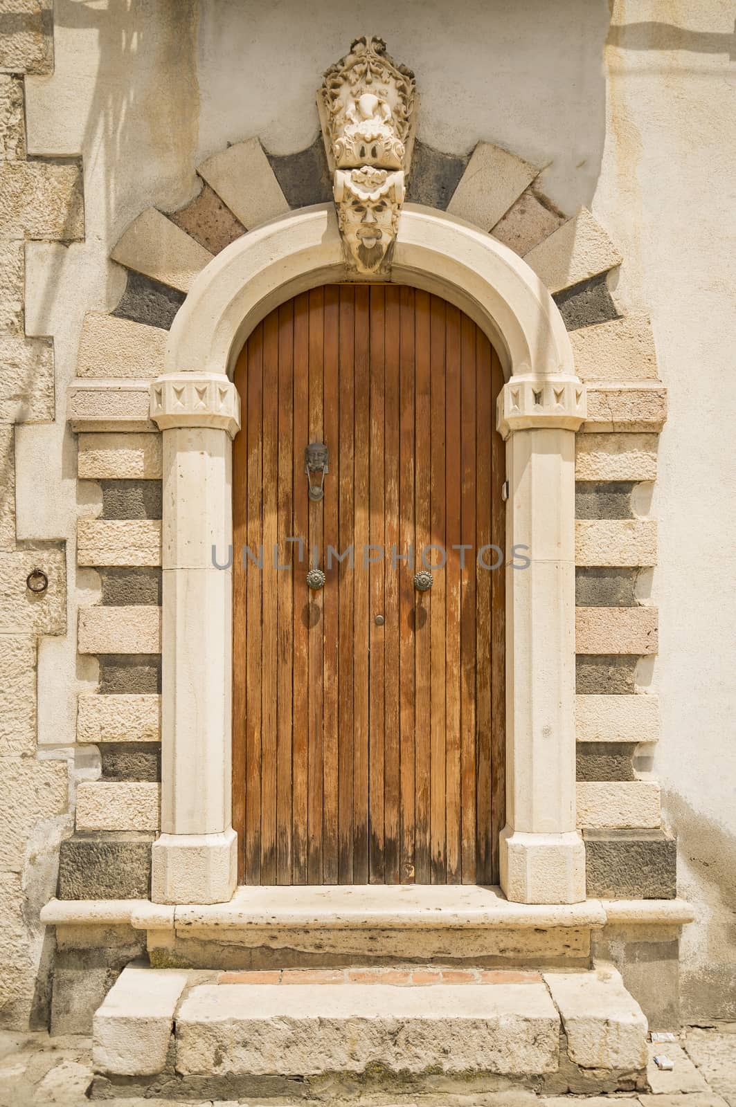The entrance wooden door in an old Italian house