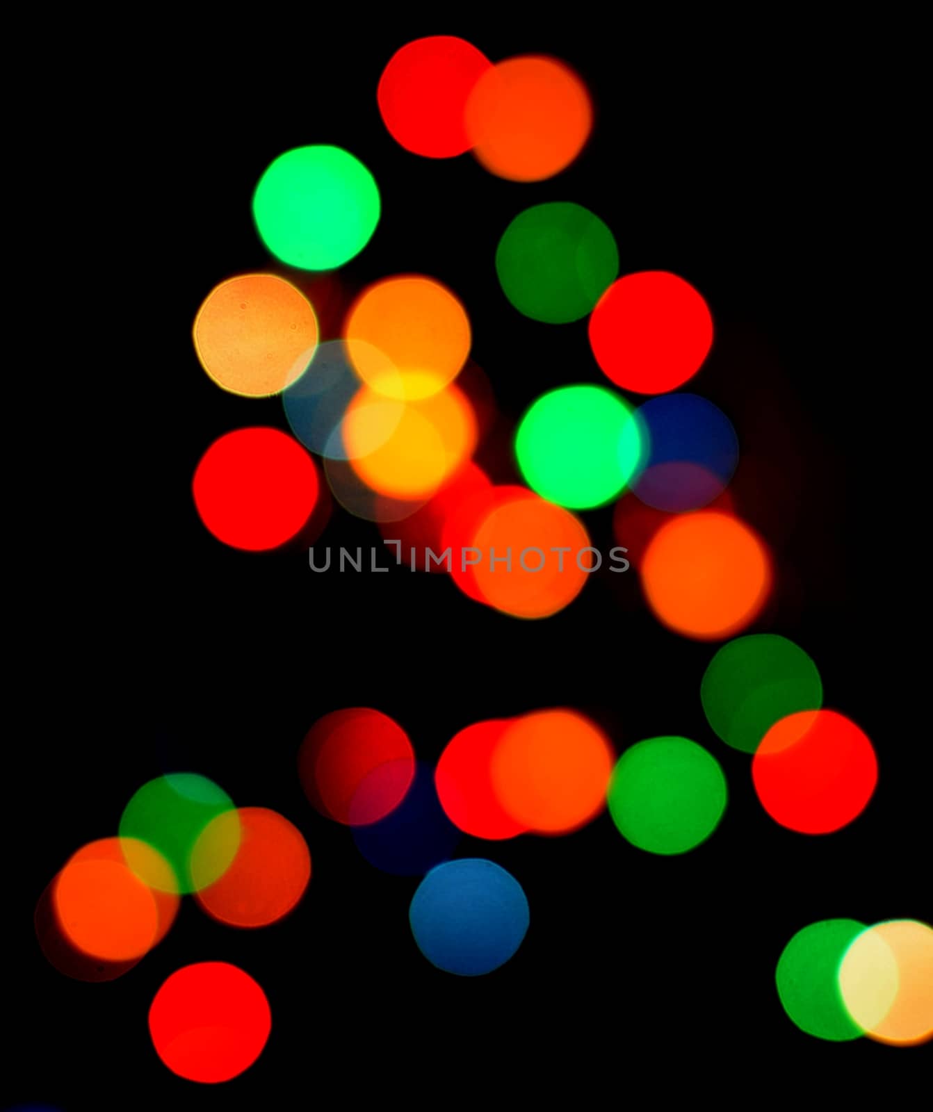 Blurred multicolor shiny light bokeh on christmas tree. 