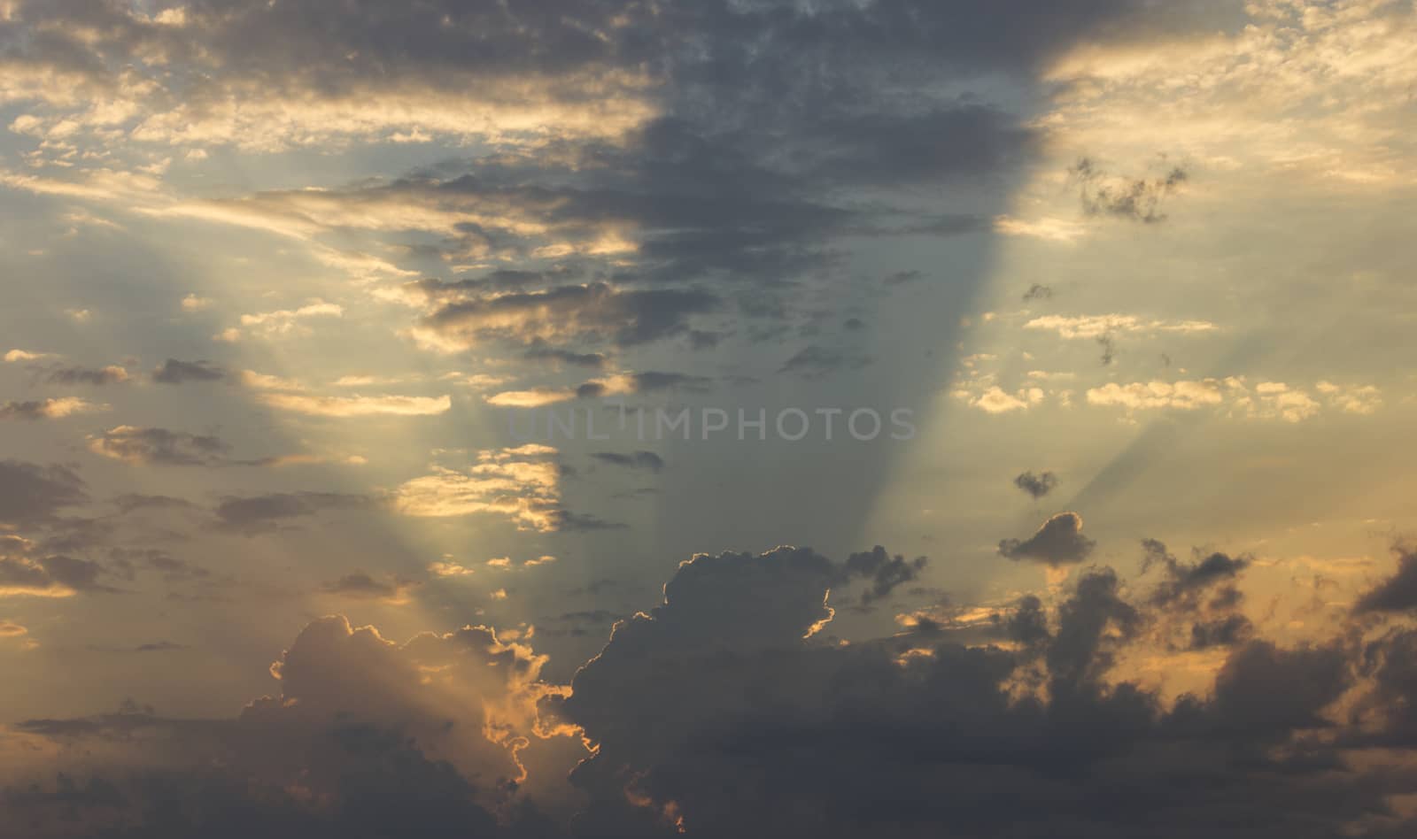 A dramatic sky with clouds and god rays.