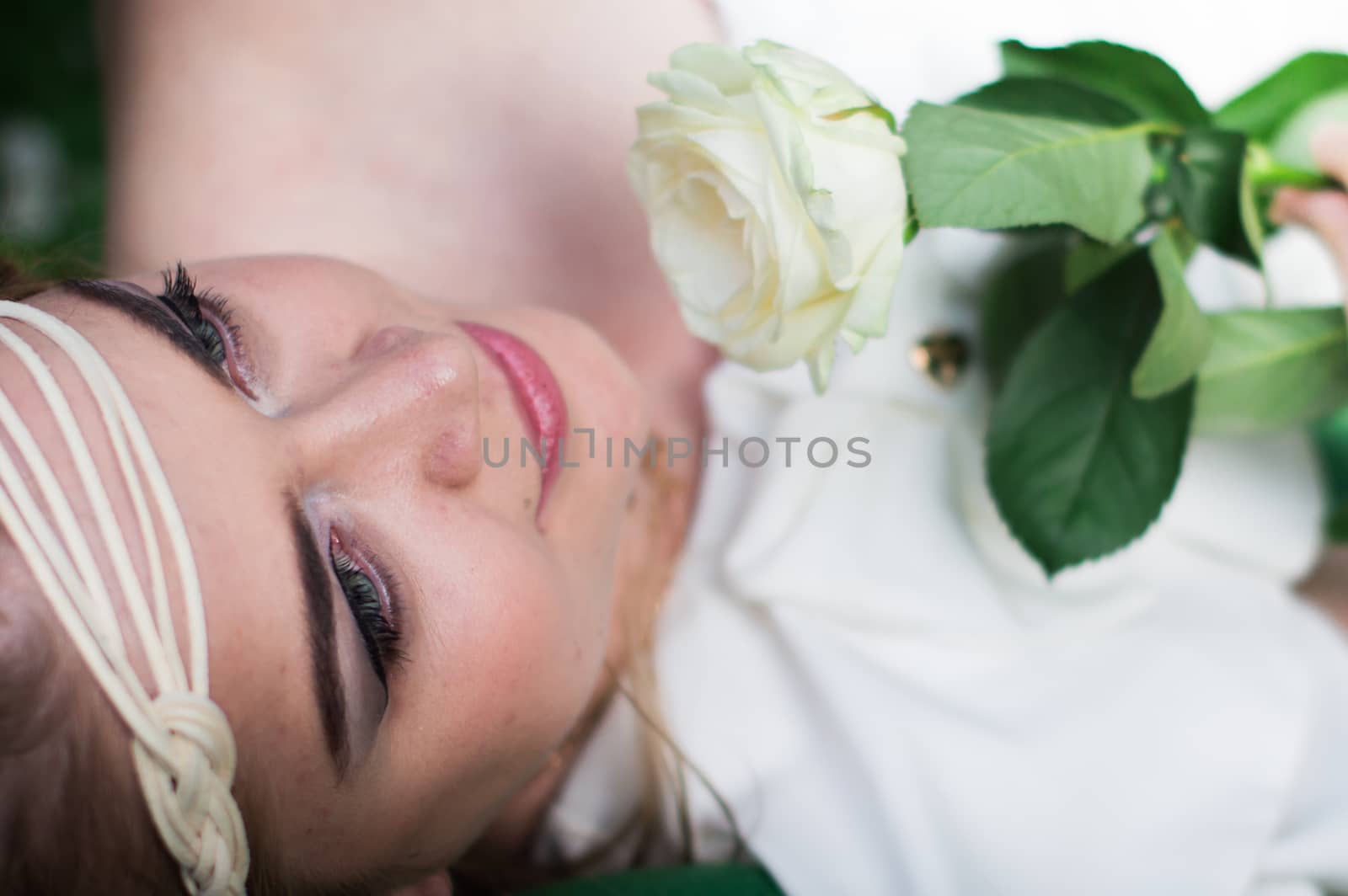 beautiful girl with a white rose in the Park