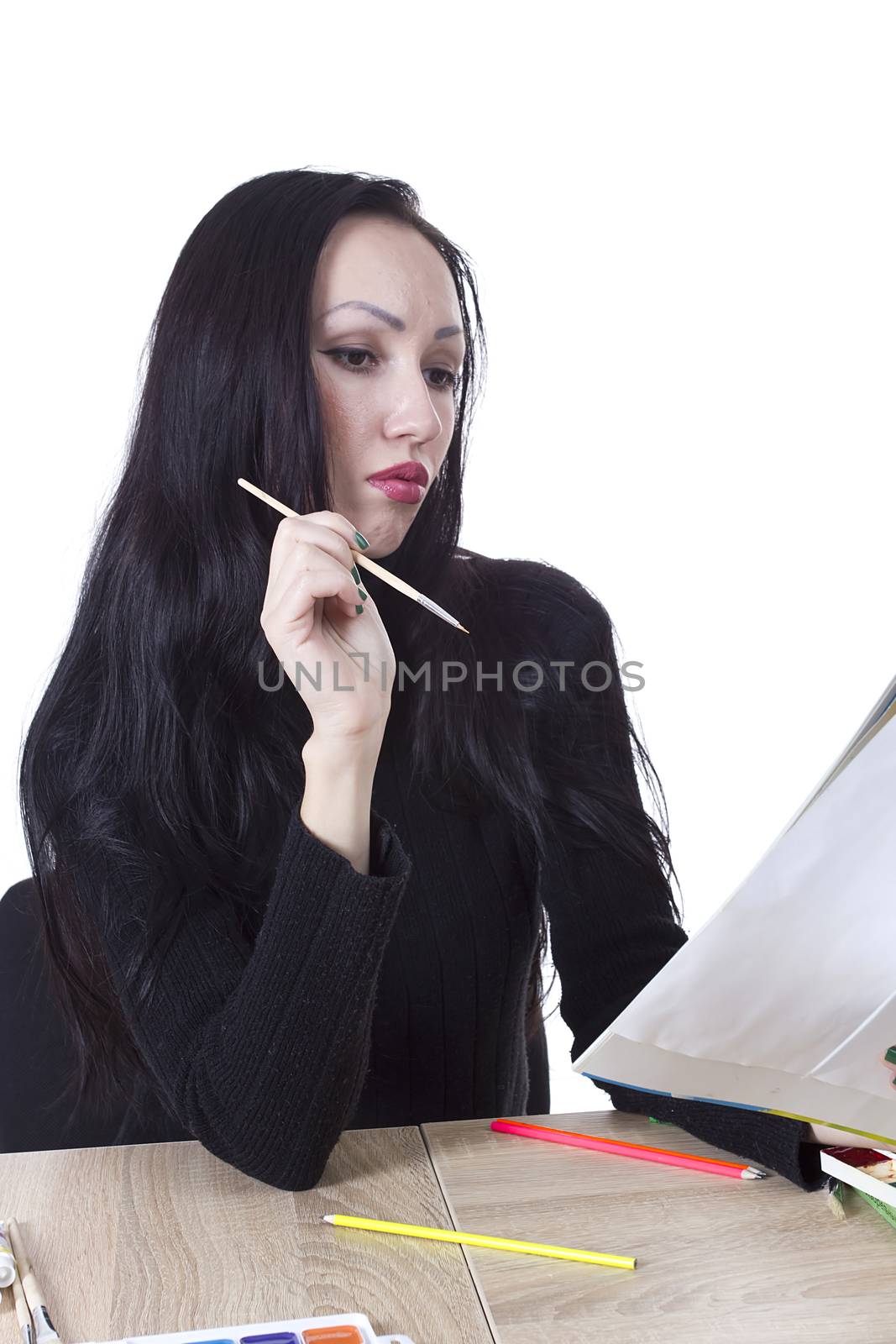 Young girl artist drawing pencils and paints