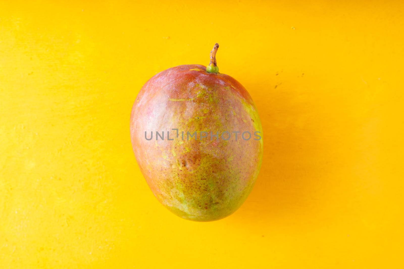 Mango on a yellow table by Deniskarpenkov