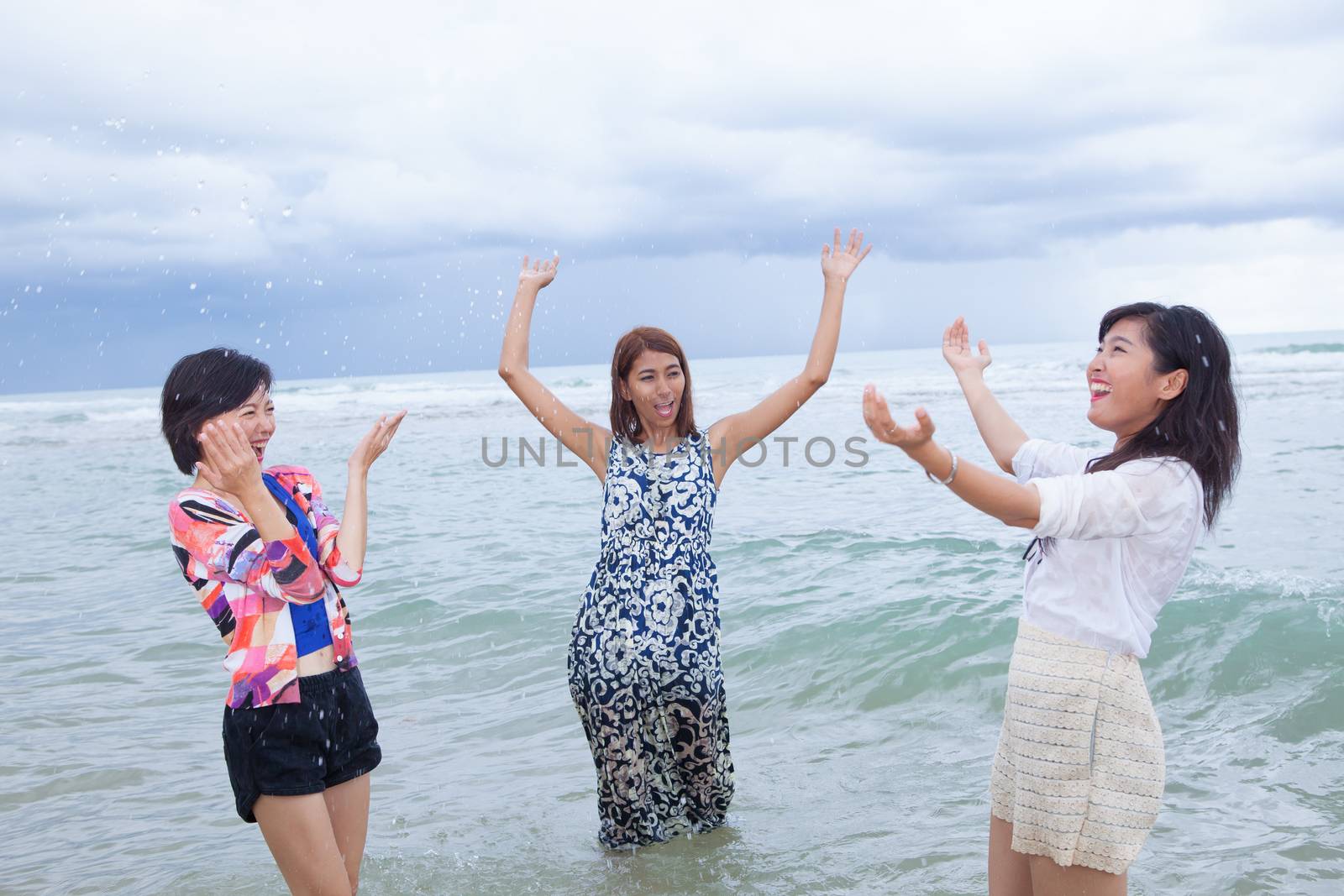 portrait group of young asain woman friend playing with happy emotion on sea beach usea for people relaxing emotion ,and enjoy vacation summer holiday 