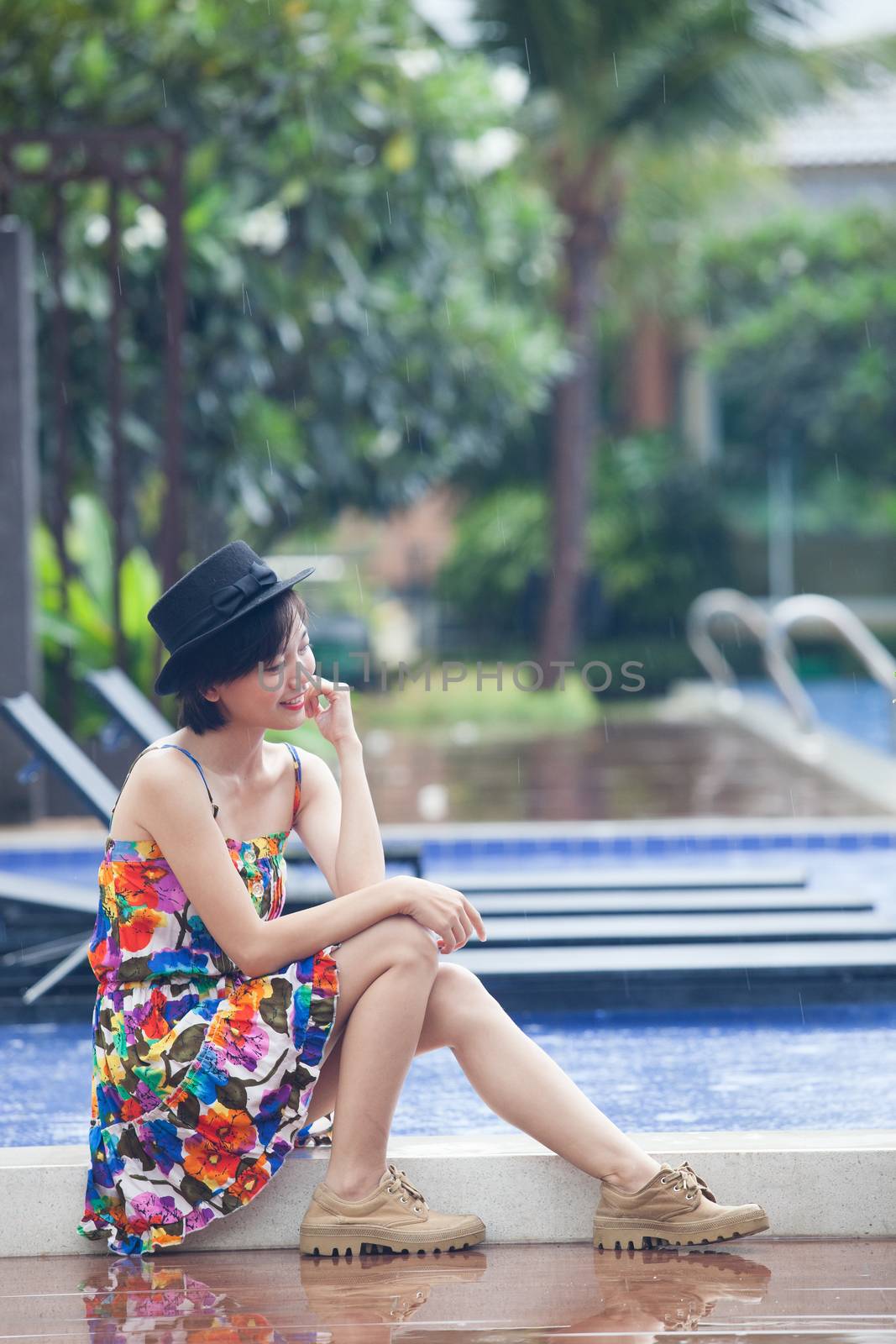 portrait of young beuatiful asian woman wearing vibrant color skirt and velvet hat