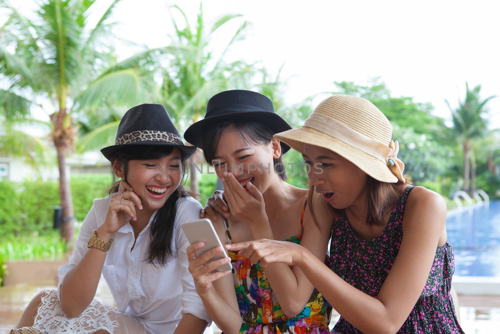 portrait of asian woman friend group looking to mobile phone and by khunaspix