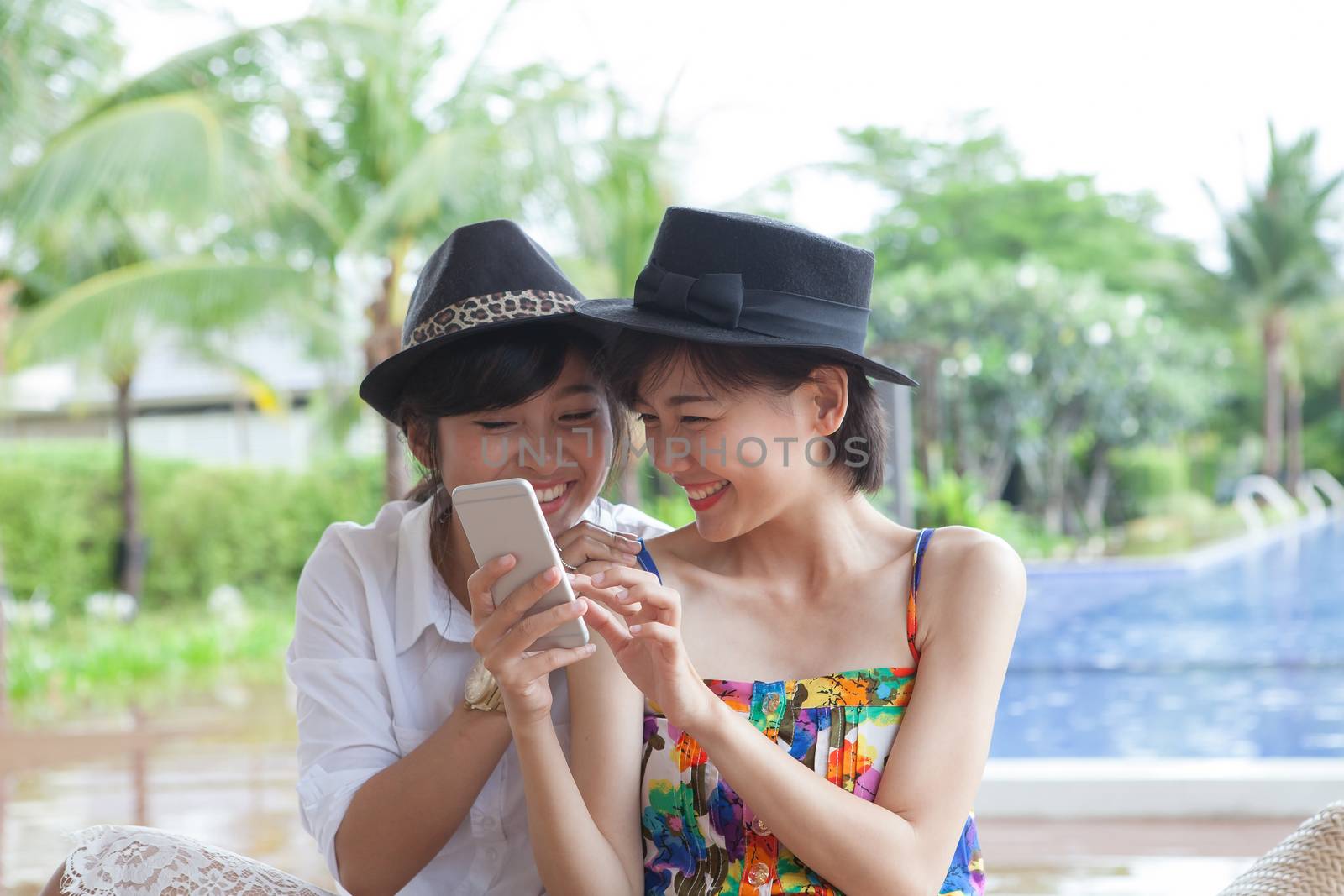 portrait of young beautiful asian woman laughing with happiness face looking to smart phone use for people and digital modern life connecting on line by mobile phone chat