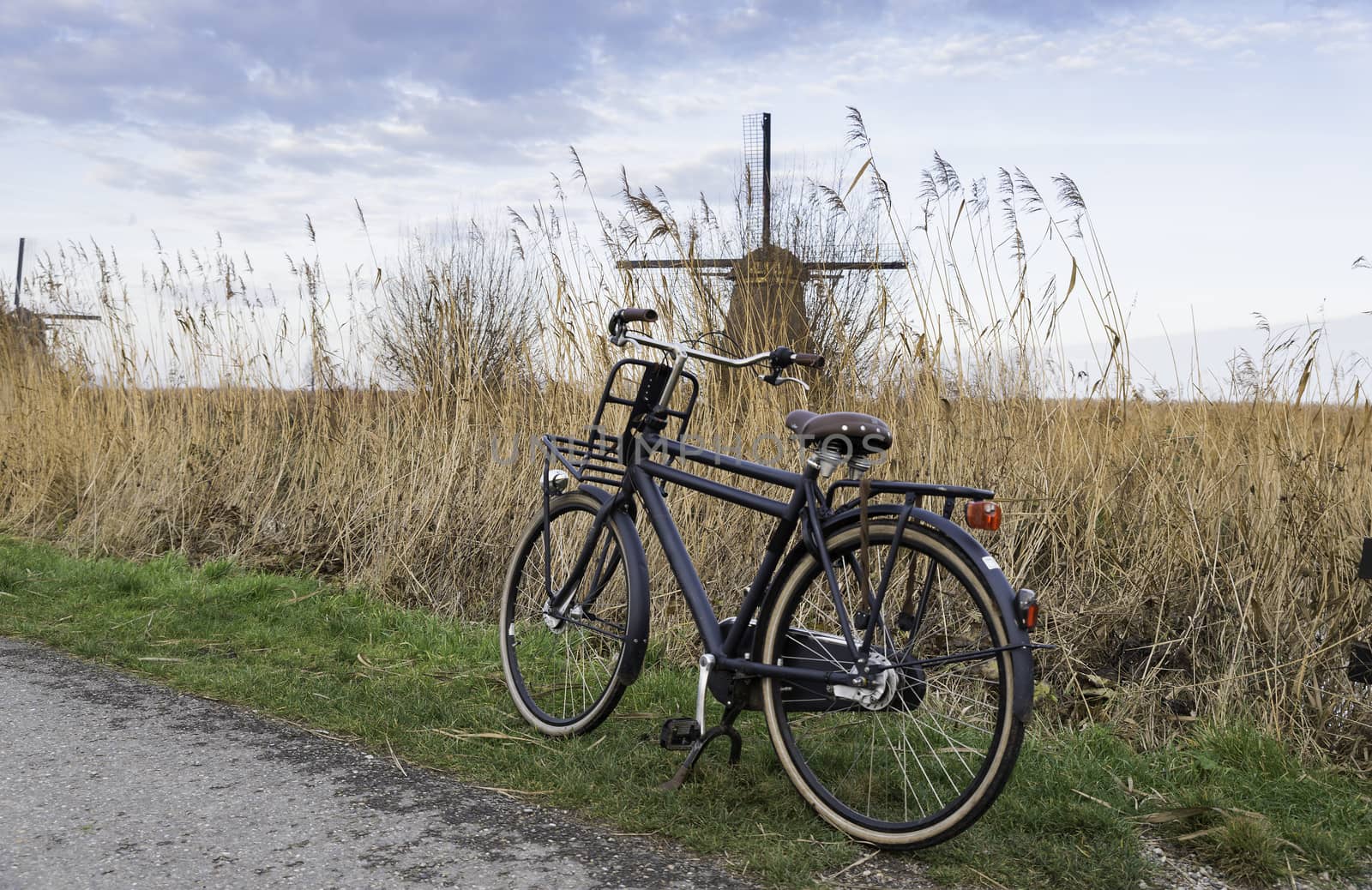 black old type bike with dutch windmill as background