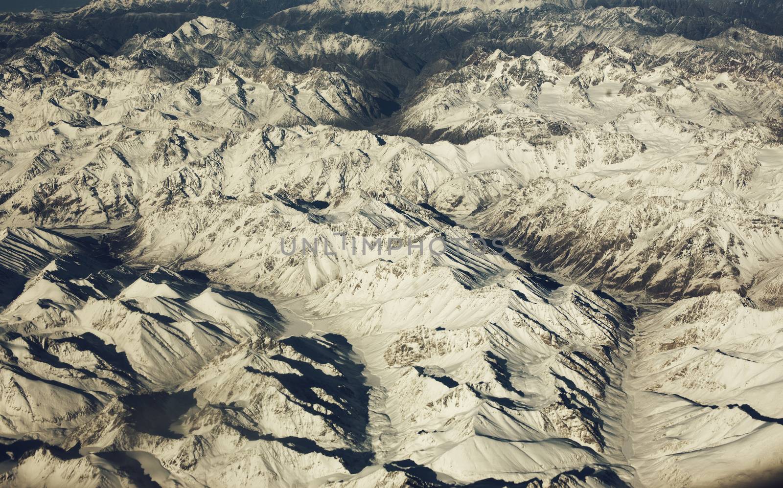 Mountain range, beautiful snowy mountains. View from the airplan by Vanzyst