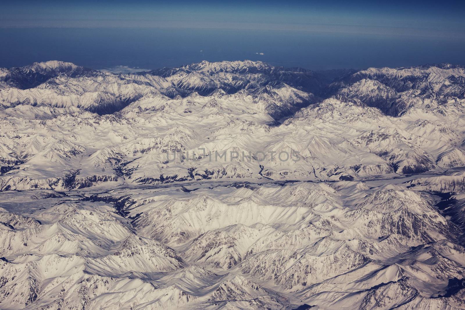 Mountain range of heights. View from the airplane by Vanzyst