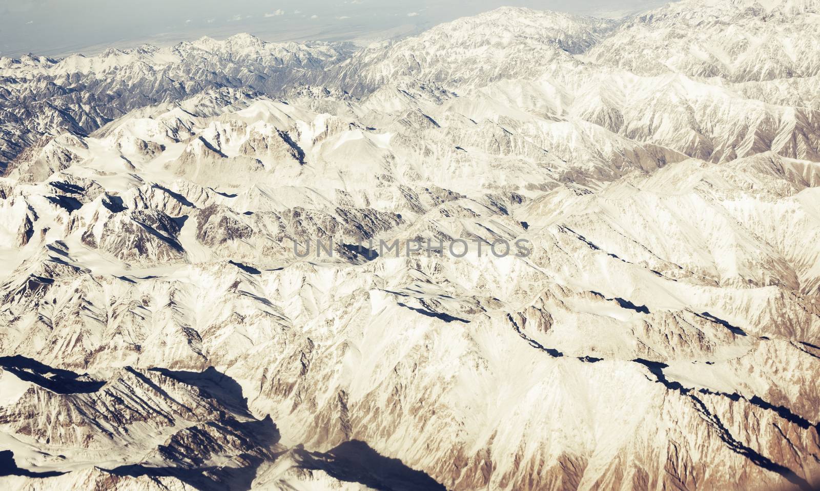Panorama mountain relief from the window of the passenger aircra by Vanzyst